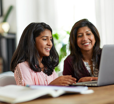 Mom and daughter browsing a laptop at home with Brightspeed DSL Internet for everyday online activities.