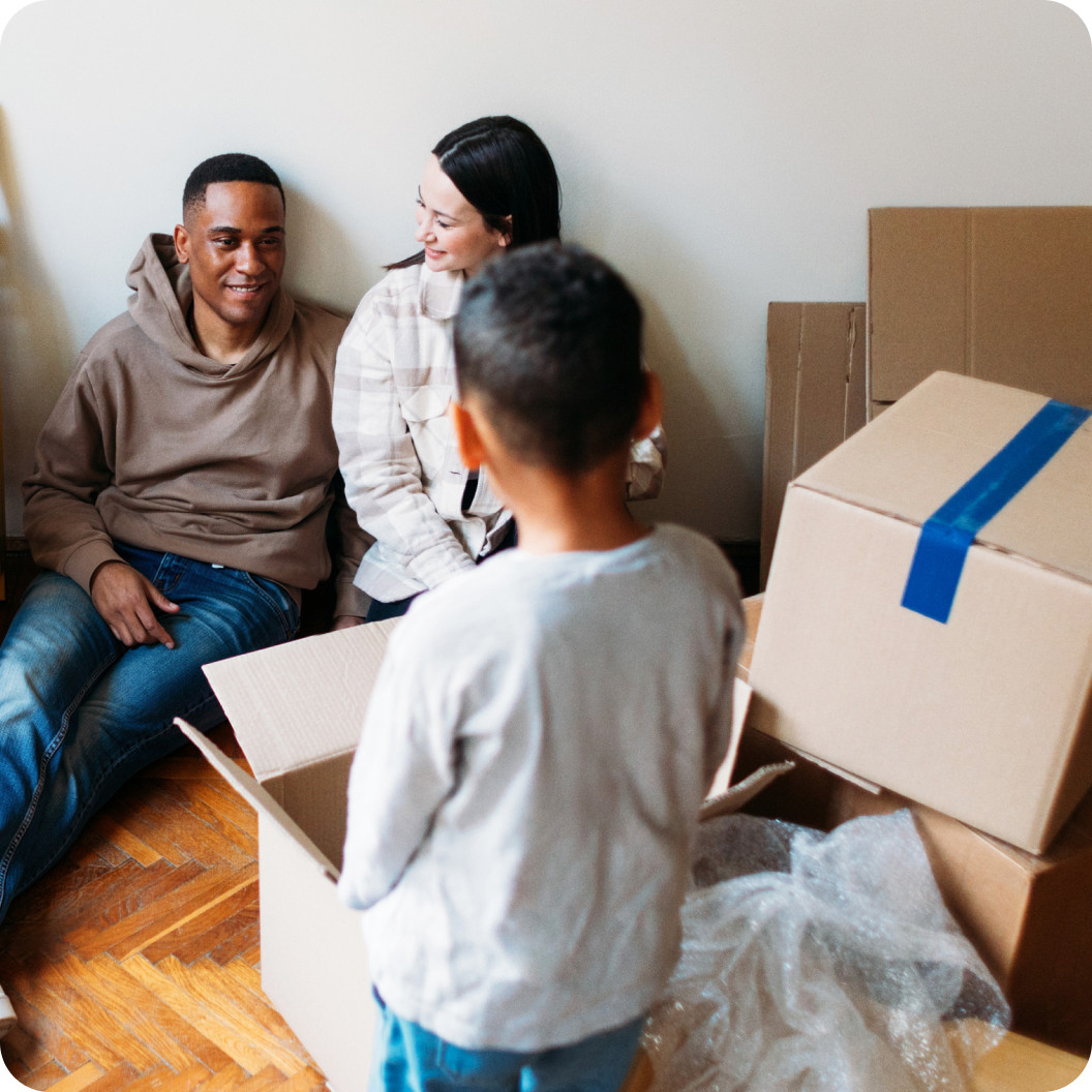Family moving into a new home and unpacking boxes, preparing for internet service with Brightspeed.