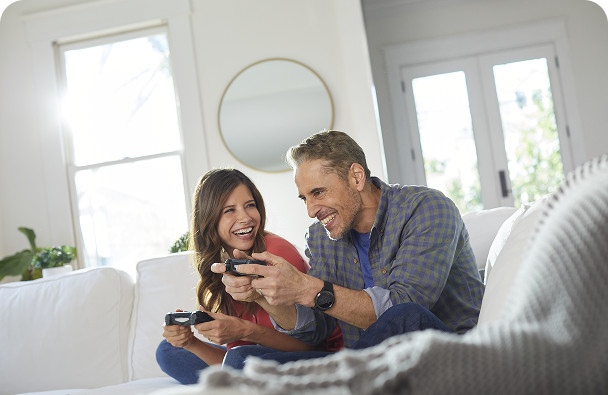 A couple is playing game with internet services provided by Brightspeed.