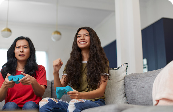 Two womens are playing game with internet services provided by Brightspeed.