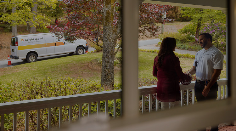 Brightspeed technician waving beside a Brightspeed High Speed Internet service van parked in a residential neighborhood, ready to assist with professional fiber installation and customer support.