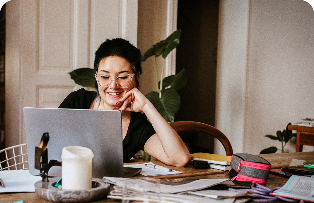Woman using a laptop to customize her Brightspeed Internet setup, including coverage, support, and connectivity services.