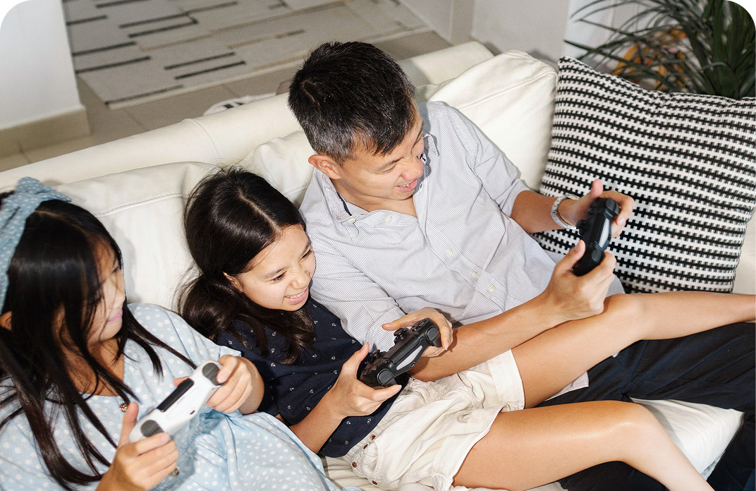 Family playing video games together on a couch with Brightspeed Fiber Internet for seamless gaming and streaming.