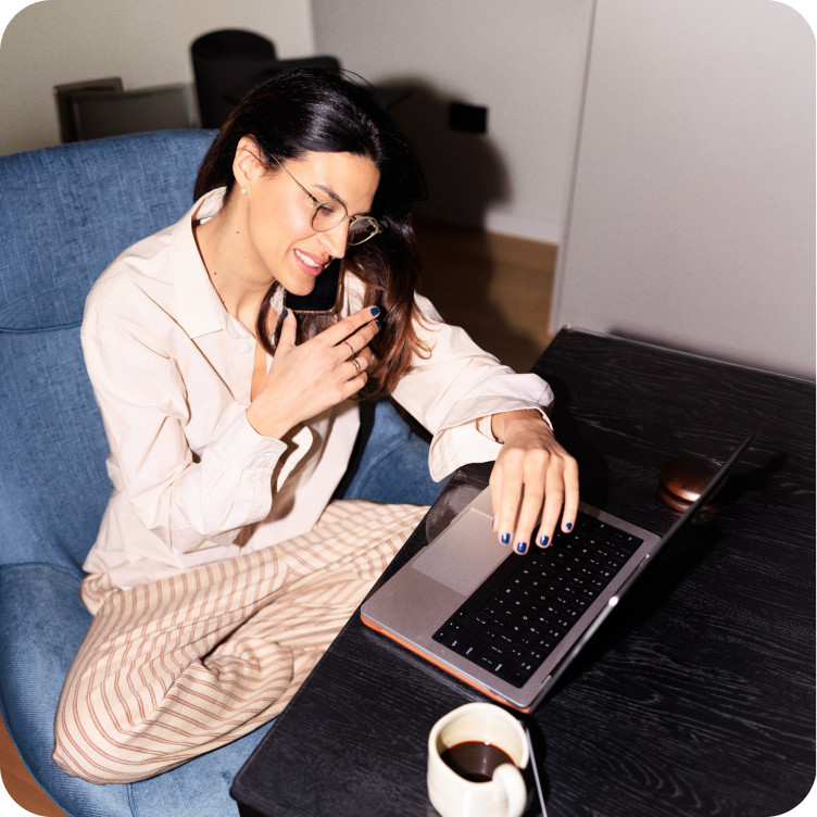 Woman using multiple devices at home with Brightspeed WiFi 7 for high-speed internet and improved performance.