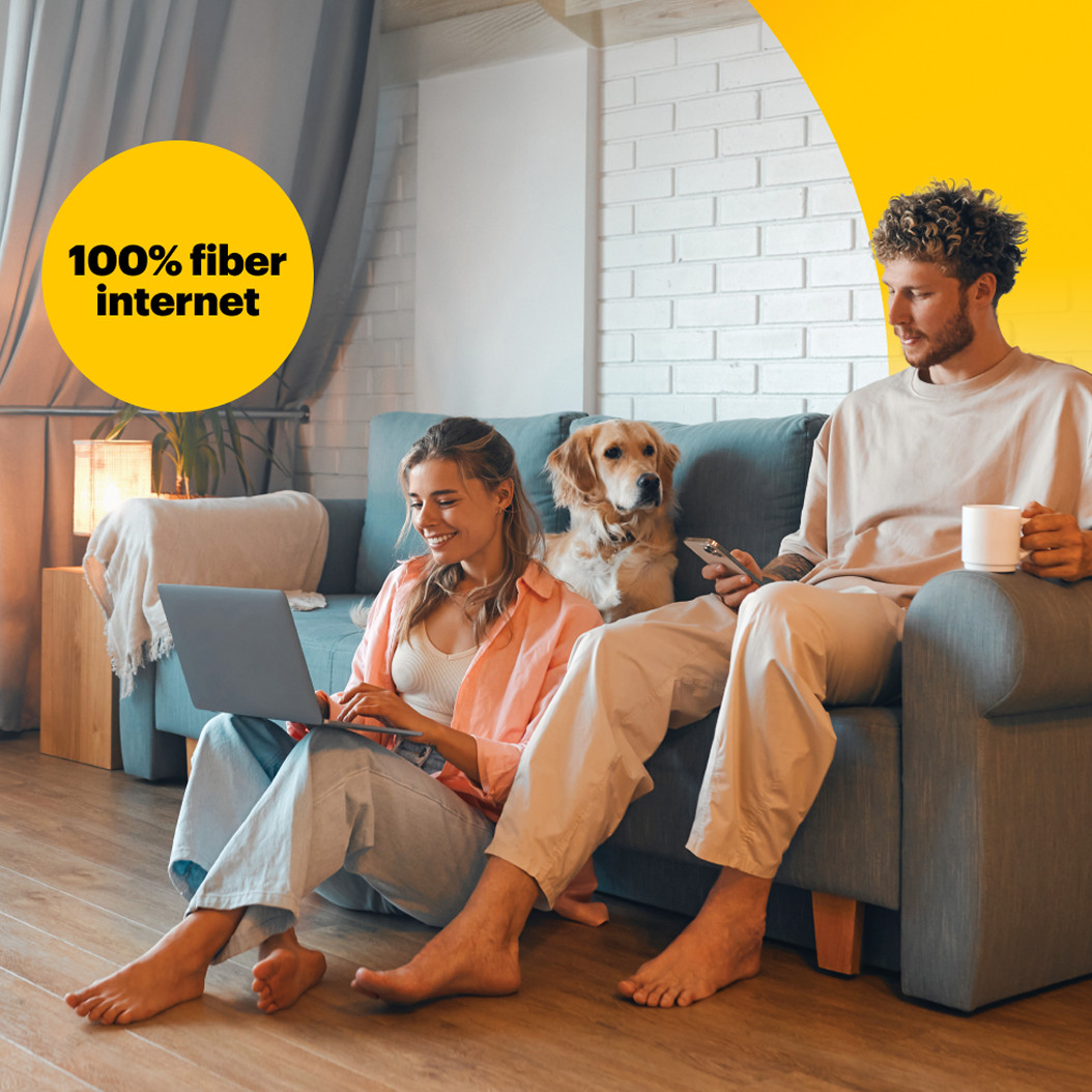 Family relaxing together on a couch with a dog, using multiple devices with Brightspeed Premium WiFi 7 and 100% fiber internet.